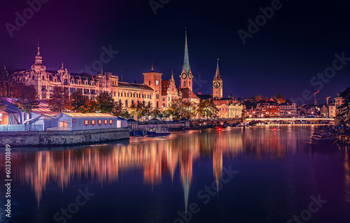 Evening panoramic view of historic Zurich city center with famous Fraumunster and river Limmat at Lake Zurich. Cityscape image of Zurich with reflection. Switzerland