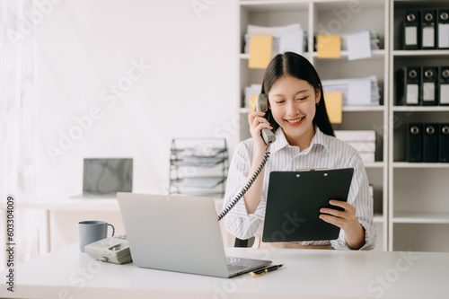 Happy asian business woman have the joy of talking on the smartphone, tablet and laptopon the  office . © Nuttapong punna