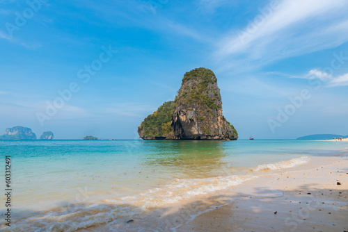 horizontal closeup photo, phra nang beach in Thailand, paradise, sunny beach, sunbathing and swimming in the sea, blue ocean and sky, relaxation and enjoyment, rock koh rang nok