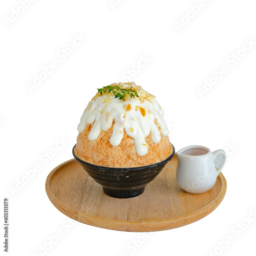 Japanese shaved ice dessert , milk tea kakigori bingsu topped with sweet whipping cream almond stick Thai tea sauce condensed milk in cafe. Traditional summer dessert menu in Japan.