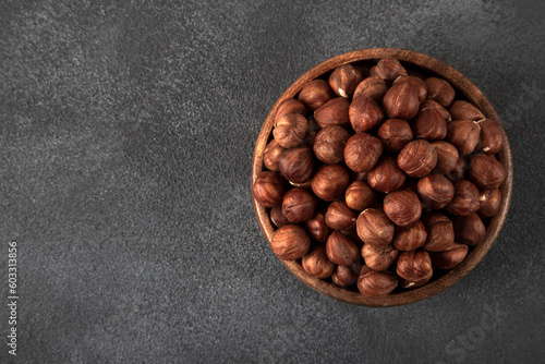 View of a bowl full of hazelnuts on a black background  © Wide Angle