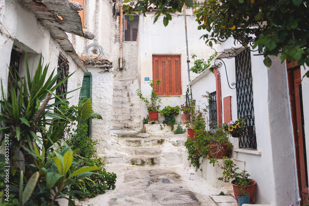 Fototapeta premium Anafiotika village street view in historical Plaka neighborhood, Attica, Athens, Greece, with a traditional colorful greek houses in a sunny day