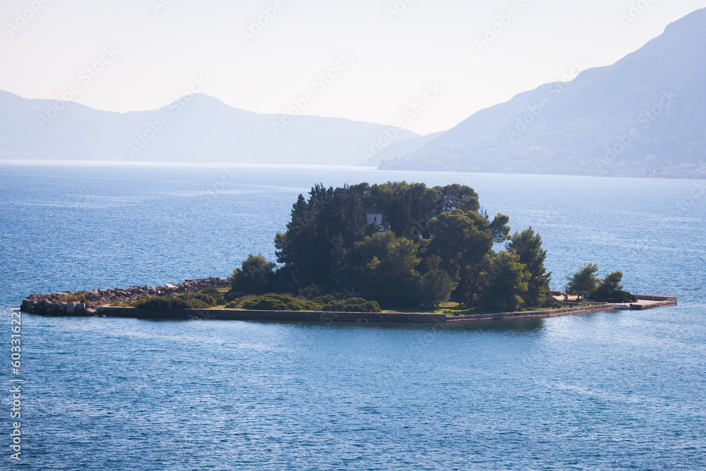View of Pontikonisi islet, Mouse Island with Byzantine chapel of Pantokrator, Kanoni, Corfu Island, Kerkyra, Greece with Ionian sea in a beautiful summer sunny day