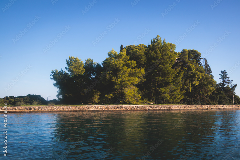 Fototapeta premium View of Pontikonisi islet, Mouse Island with Byzantine chapel of Pantokrator, Kanoni, Corfu Island, Kerkyra, Greece with Ionian sea in a beautiful summer sunny day