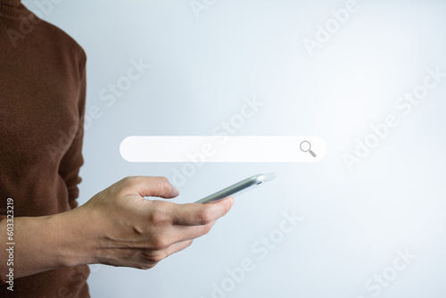 Search Engine optimization SEO concept, Businesswoman is using smartphone to search for information on Internet, Using the search bar, Wireless Network, big data and accessing website information.