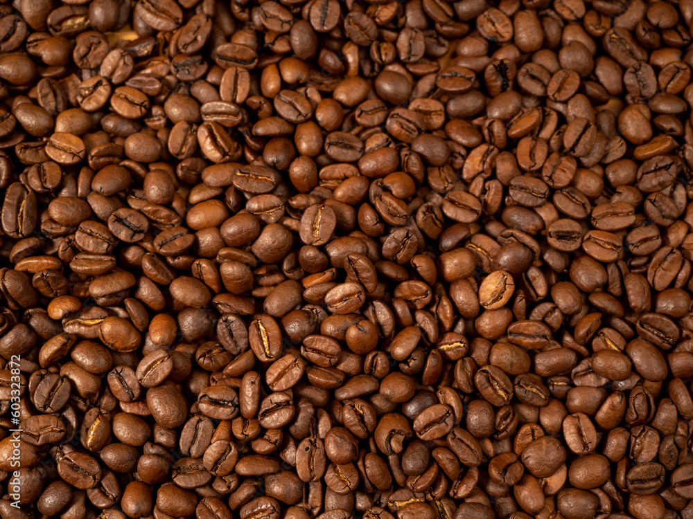 Background from roasted coffee beans. Scattered coffee beans. Coffee beans close up. Background from roasted coffee beans. Scattered coffee beans. Coffee beans close up.