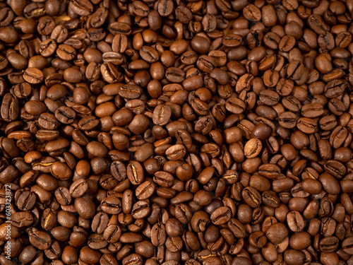 Background from roasted coffee beans. Scattered coffee beans. Coffee beans close up.