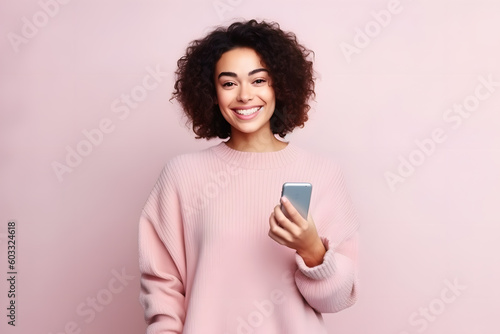 african woman with pink sweater isolated on pink background texting on mobile phone
