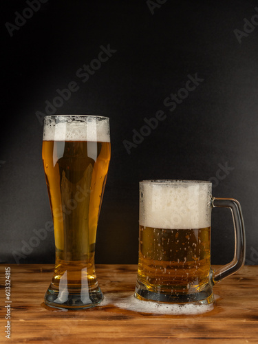 A glass of cold beer on a dark background. Glass of beer close-up.