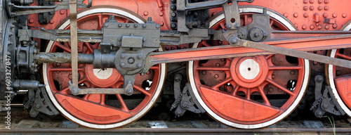 Big red wheels of a steam locomotive