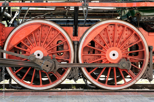 Big red wheels of a steam locomotive