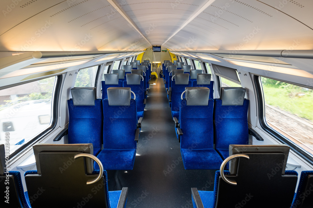 Empty seats on a passenger train in Europe. Wide-angle view, day time, no people Empty seats on a passenger train in Europe. Wide-angle view, day time, no people