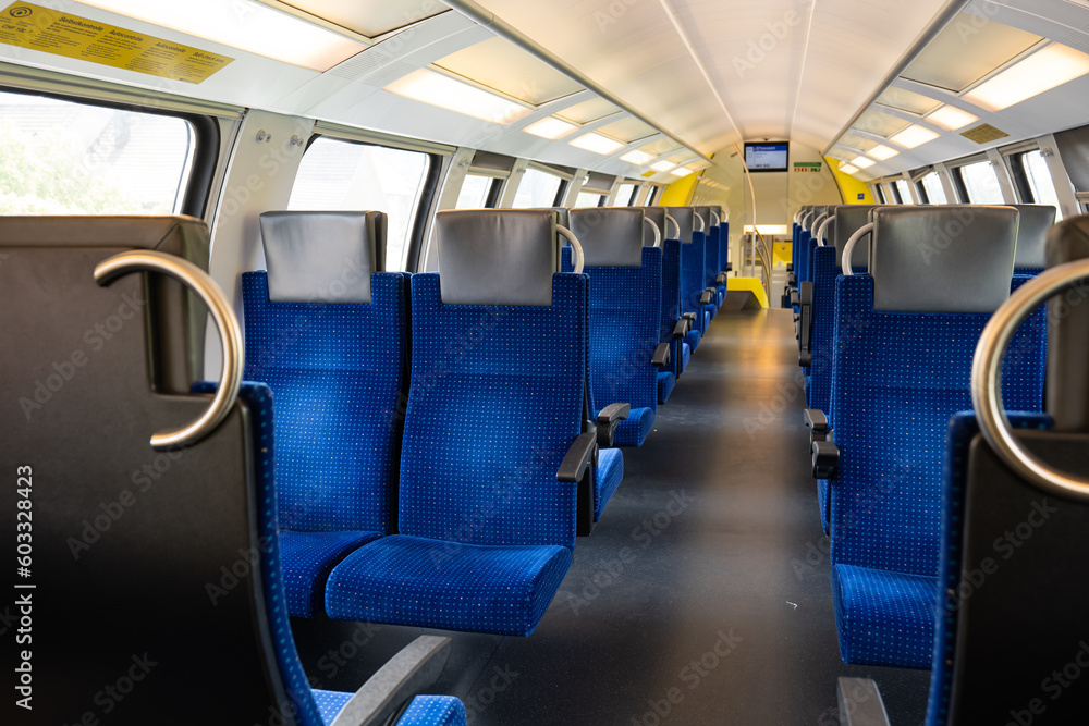 Empty seats on a passenger train in Europe. Wide-angle view, day time, no people Empty seats on a passenger train in Europe. Wide-angle view, day time, no people