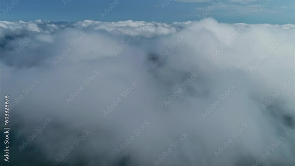 Aerial flyover and descent into clouds revealing lake with island Aerial flyover and descent into clouds revealing lake with island