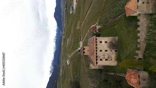 Vertical aerial view of scenic Castel Nanno, a castle in the middle of the idyllic Italian village of Val di Non.  photo
