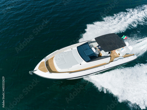 young amazing woman relax on the yacht, aerial view