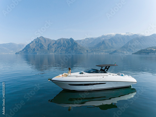 young amazing woman relax on the yacht, aerial view