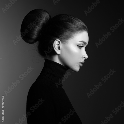Black and white fashion art studio portrait of beautiful elegant woman in black turtleneck. Hair high beam, perfect profile face. Elegant beauty style