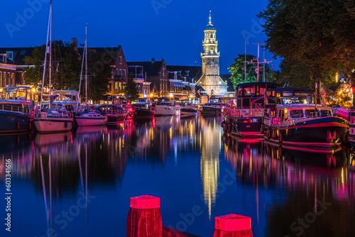 View of the illuminated historical part of the city of Lemmer in Friesland, Netherlands after sunset photo