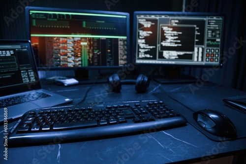 Keyboard and screens. Cyber criminal haker dark room for massive attack of corporate big data servers
