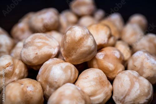 front macro shot of stacked hazelnuts with black background, Detailed shot of fresh unshelled hazelnuts