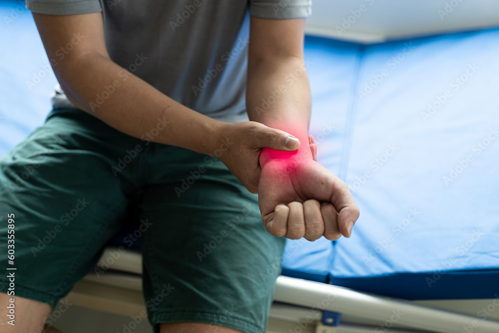 Physiotherapist examining patient's wrist by pressing on wrist bones in clinic room wrist joint inflammation have joint pain rheumatism or arthritis