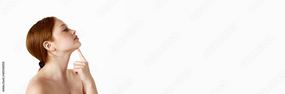 Portrait of young, redhead girl with ponytail against white background. Perfect chin line. Concept of natural beauty, plastic surgery, cosmetology, cosmetics, skin care. Banner. Copy space for ad Portrait of young, redhead girl with ponytail against white background. Perfect chin line. Concept of natural beauty, plastic surgery, cosmetology, cosmetics, skin care. Banner. Copy space for ad