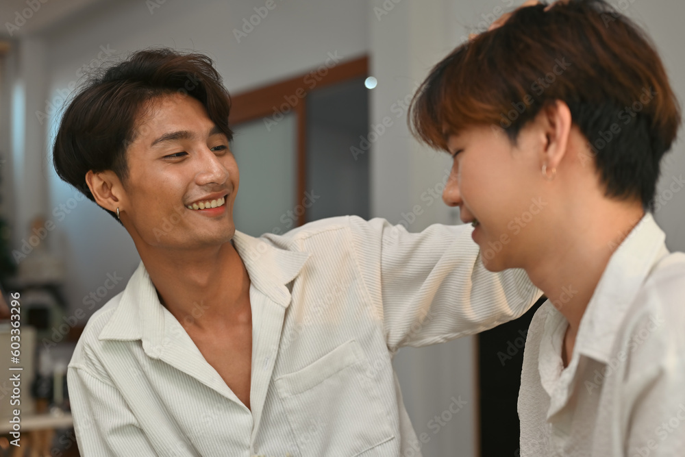 Young gay boy with Asian colored skin gently stroking his boyfriend's head with love and affection, Support LGBT equality and expressions of LGBT love. Young gay boy with Asian colored skin gently stroking his boyfriend's head with love and affection, Support LGBT equality and expressions of LGBT love.