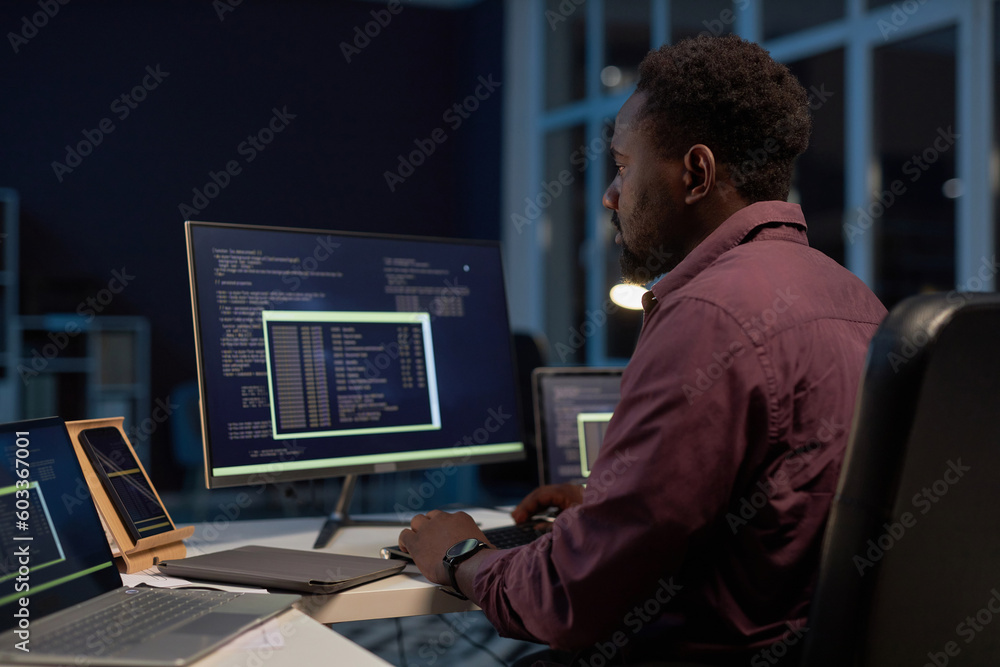 African American developer concentrating on development of software on computer African American developer concentrating on development of software on computer