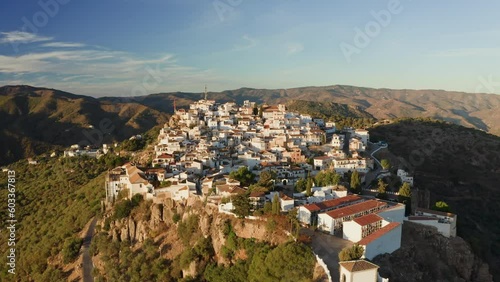 Aerial drone shot of a classic white Andalusian village Comares located on a mountain top near Malaga. photo