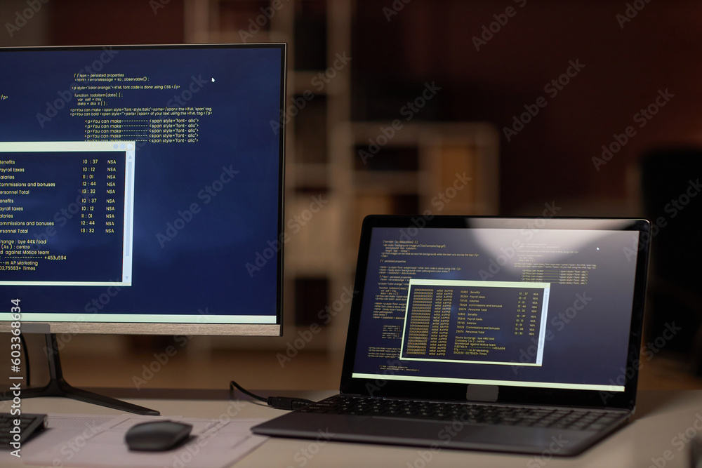 Close-up of computers with security codes on monitors on workplace of programmer Close-up of computers with security codes on monitors on workplace of programmer