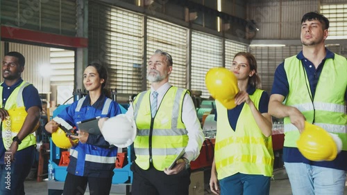Group of diverse engineering and worker finished work and walking together, Team showing unity and teamwork in factory workplace, Industrial and manufacturing happy people at work concept.