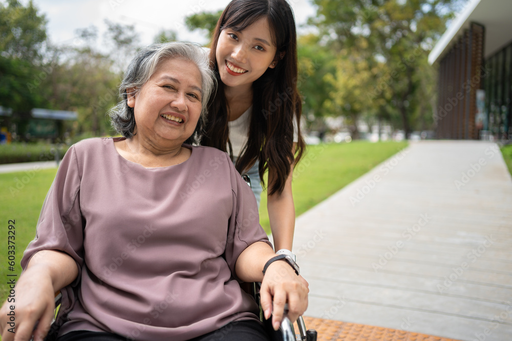 Asian careful caregiver or nurse taking care of the patient in a wheelchair. Concept of happy retirement with care from a caregiver and Savings and senior health insurance, a Happy family