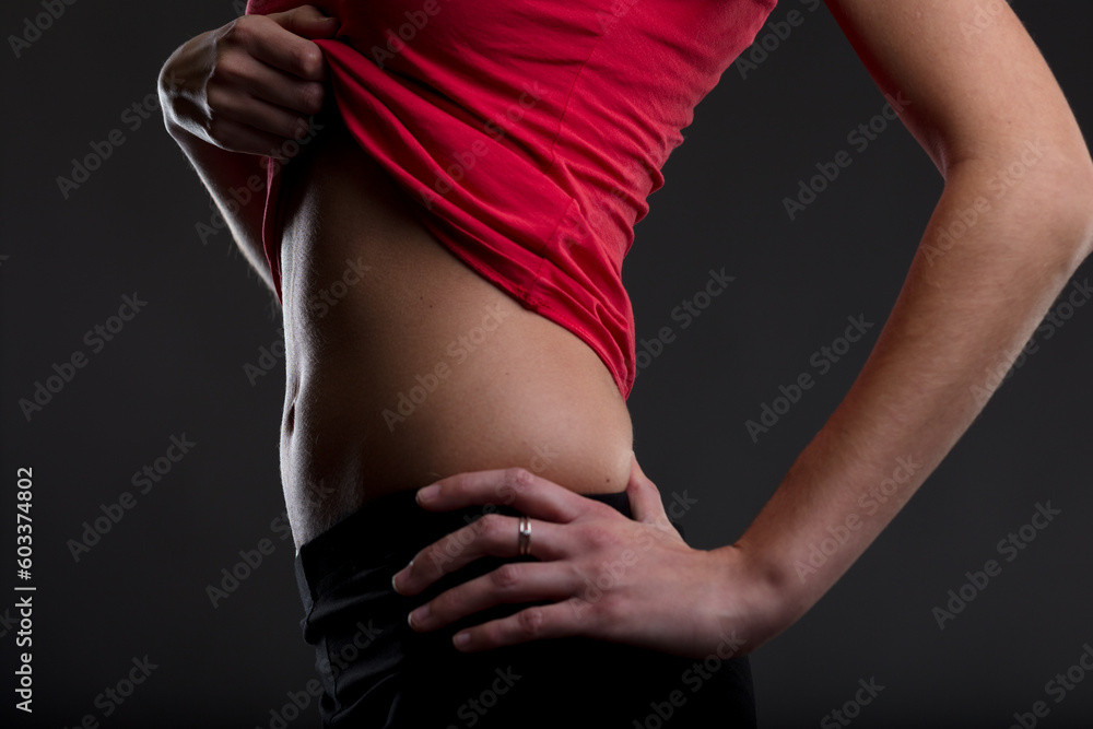 Fototapeta premium Diet, exercise yield woman's flat belly