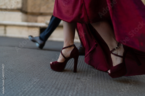 Red block heel shoes under a red glamorous dress