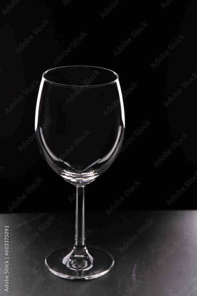 photo glass of wine on a black background