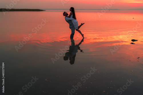 Lovers in the lake at sunset