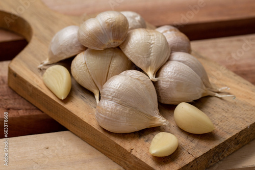 Garlic  garlic slices  garlic cloves  on a wooden tray
