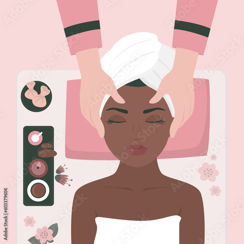 Young woman enjoying relaxing facial massage treatment. Woman lying on back while masseur massaging her face. Facial treatments. Spa face massage. Happy girl portrait.