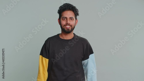 Excited amazed indian man touching head and showing explosion, looking worried and shocked, celebrating success idea. Looking surprised of win wow hindu guy isolated alone on gray studio background photo