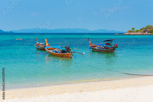 Sunrise Beach in Ko Lipe  Thailand. Long-tail boats in azure water.