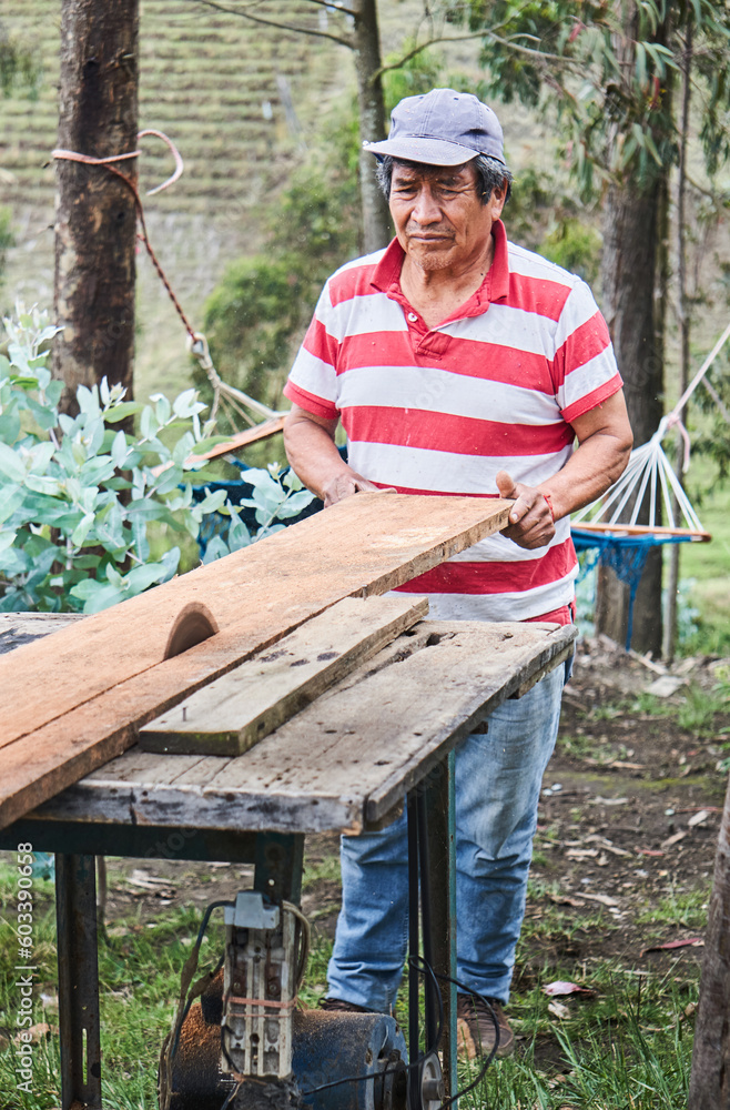 Ethnic male woodworker putting plank on table in farmland Ethnic male woodworker putting plank on table in farmland