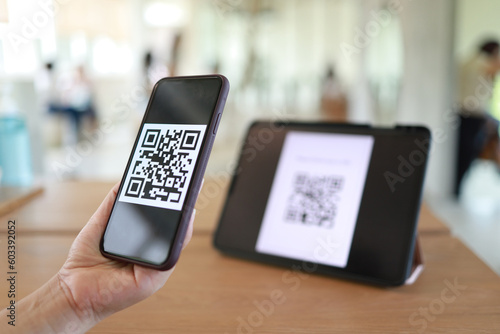 Qr code payment. Woman scanning QR code online shopping cashless technology concept.