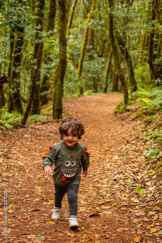 A boy having fun on the trail in the evergreen cloud forest of Garajonay National Park, La Gomera, Canary Islands, Spain © unai