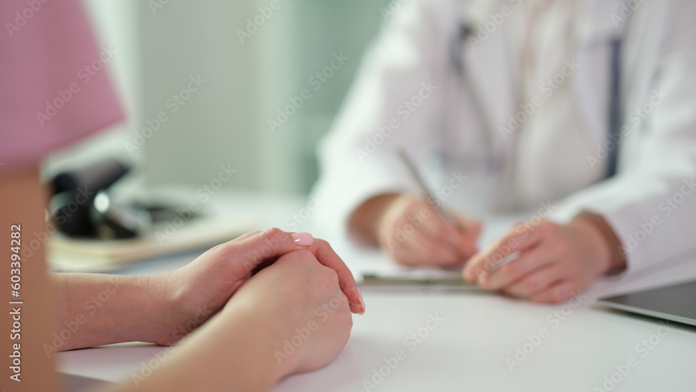Patient hands on table during visit to doctor in clinic closeup. Medicare concept Patient hands on table during visit to doctor in clinic closeup. Medicare concept