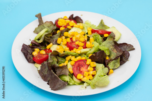 Delicious light vegetable salad made from tomatoes, canned corn, cucumber and lettuce