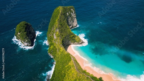 Pristine sandy Kelingking Beach on Nusa Penida island Bali. Turquoise ocean water by green limestone cliffs. Famous natural landmark.