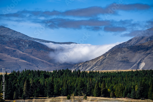 Cloud sitting in the valley between two mountains in the south island of New Zealand