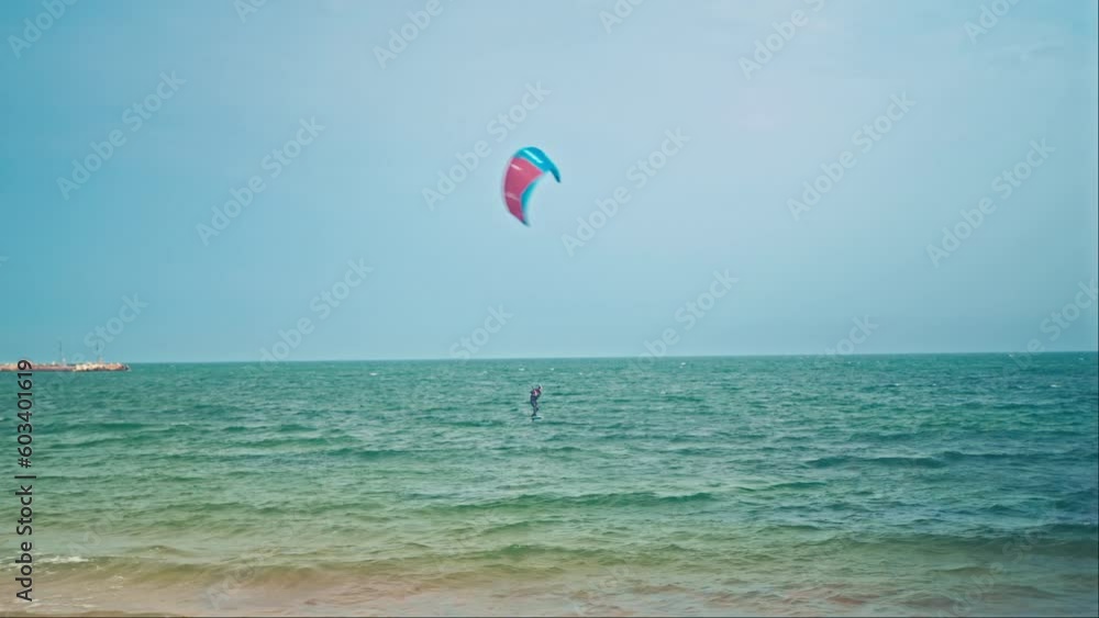Water sport, hobby. kitesurfing on the shore of Ocean, a person catches wind, wide angle Water sport, hobby. kitesurfing on the shore of Ocean, a person catches wind, wide angle