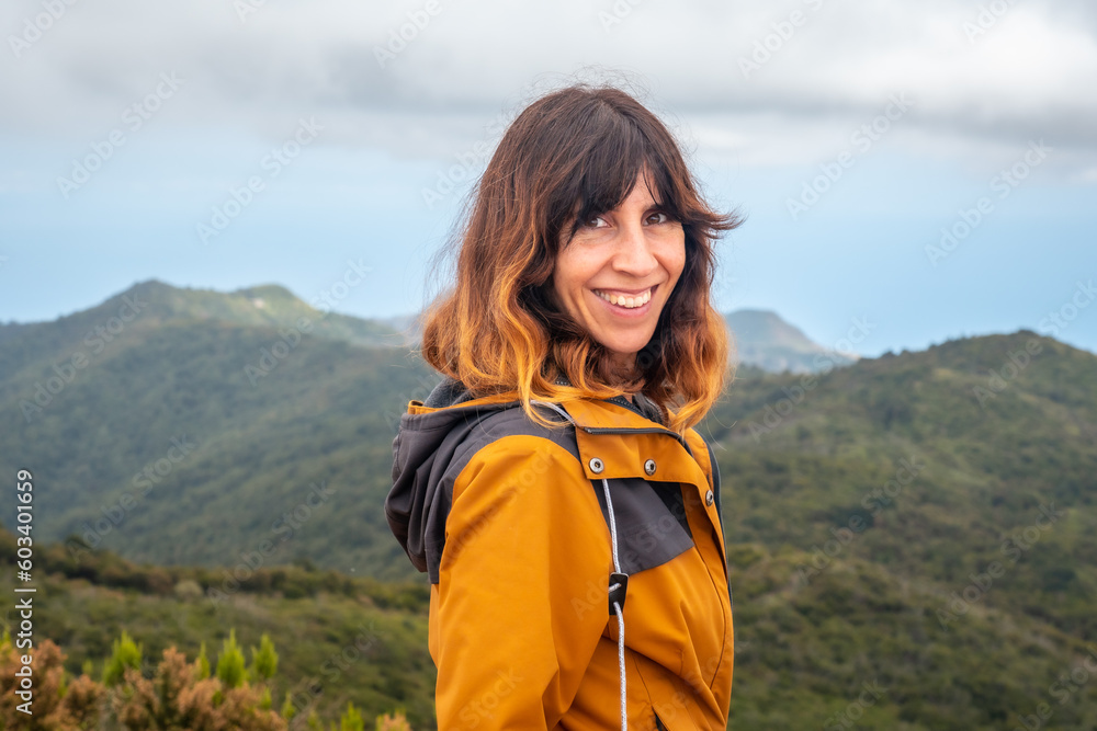 Woman smiling after finishing trekking on top of Garajonay in La Gomera, Canary Islands